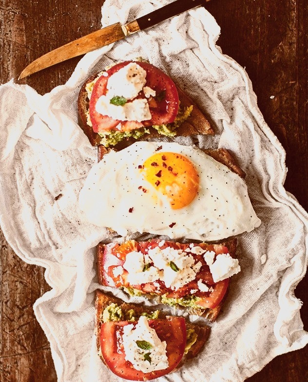 avocado toast with goat cheese and tomato.